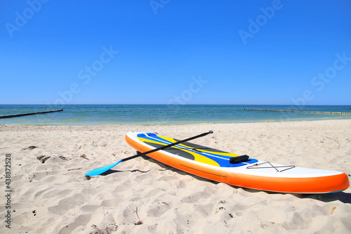 Fototapeta Naklejka Na Ścianę i Meble -  A stand up paddle on the beach at baltic sea, Germany