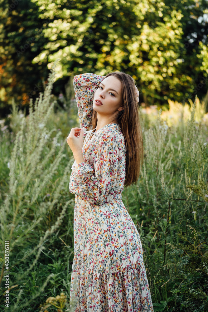 beautiful woman in a summer dress and boots walks green plants. beautiful woman in a summer dress and boots walks green plants.