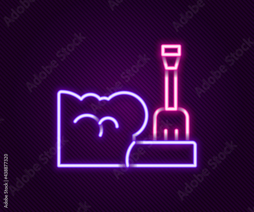 Glowing neon line Shovel in snowdrift icon isolated on black background. Colorful outline concept. Vector