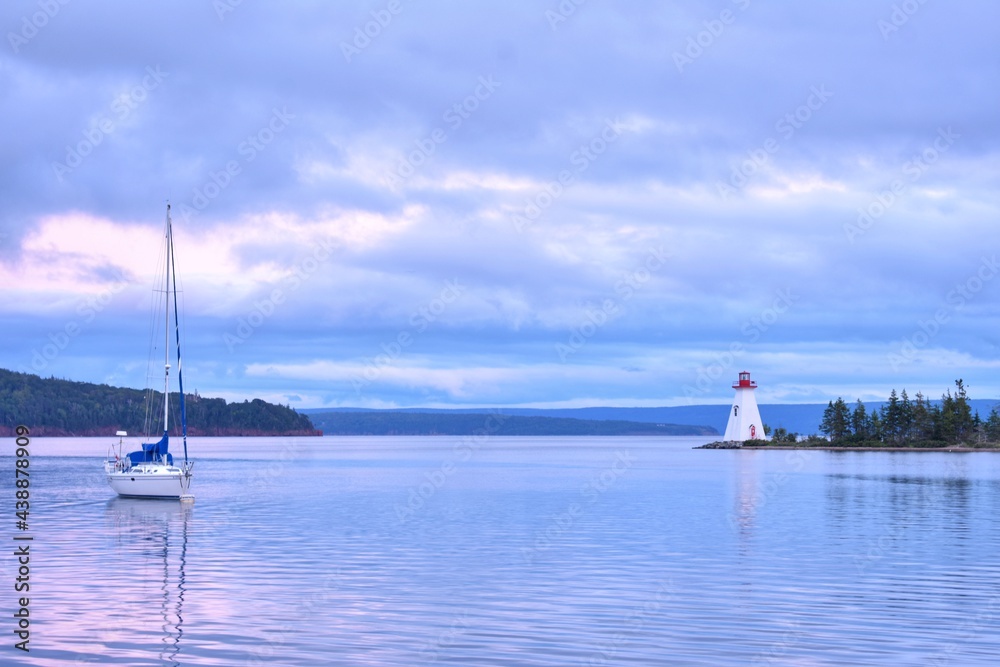 Sailboat and Lighthouse After the Storm in Nova Scotia Sailboat and Lighthouse After the Storm in Nova Scotia