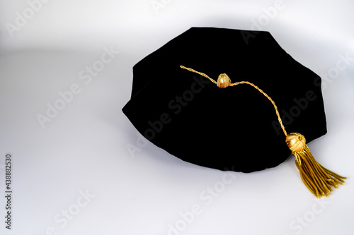 Isolated traditional black phd doctoral tam cap with gold tassel	
 photo