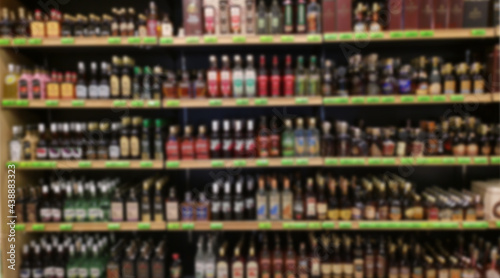 Alcohol showcase blurred background. Blurred abstract background of shelf in supermarket.