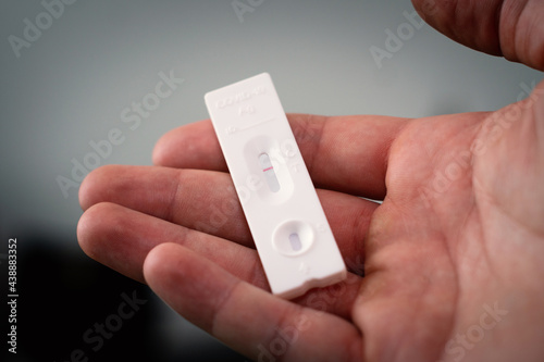 Corona negative self-test at home, holding in hand