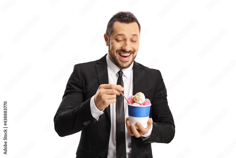 Young businessman eating ice cream from a paper cup Young businessman eating ice cream from a paper cup