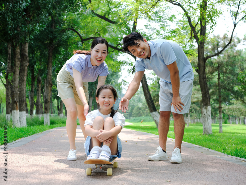 A Happy family of three skateboarding