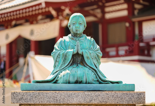 Bronze statue oxidized by patina of sect founder Jodoshu Honen named Seishimaru at the age of nine praying at two hands when he became monk as his late father wished. photo