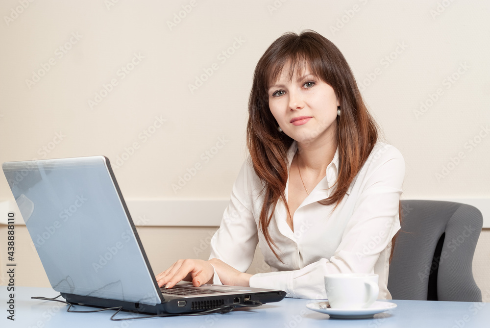 Young woman using laptop in the office Young woman using laptop in the office