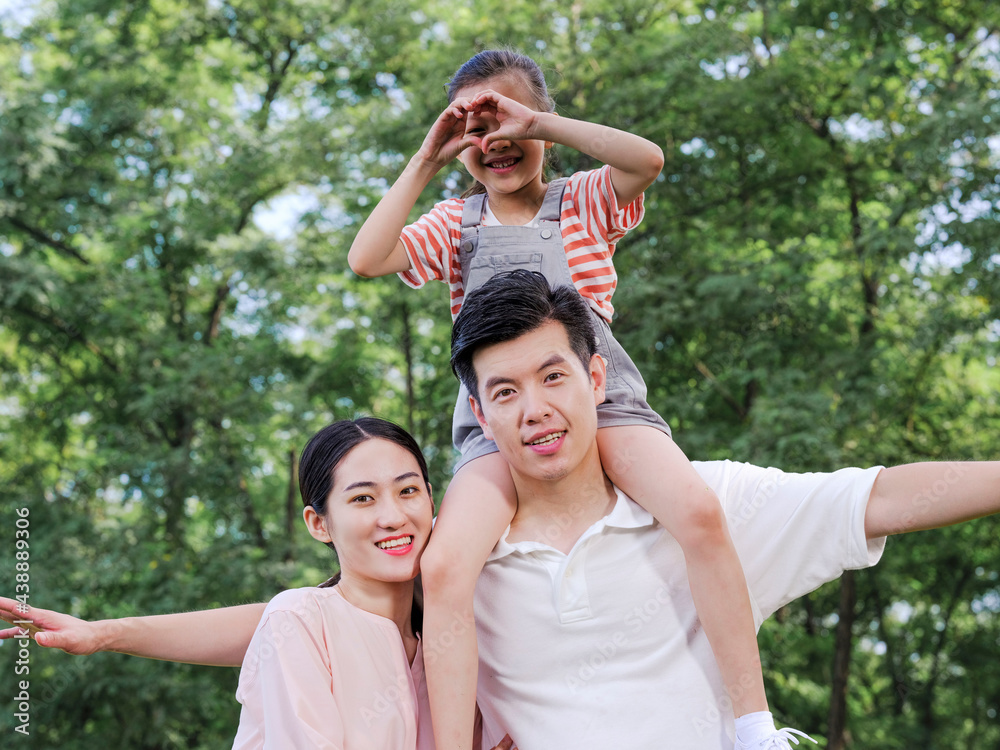 Happy family of three playing in the park