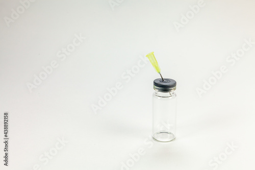 Glass bottle for vaccines on white background