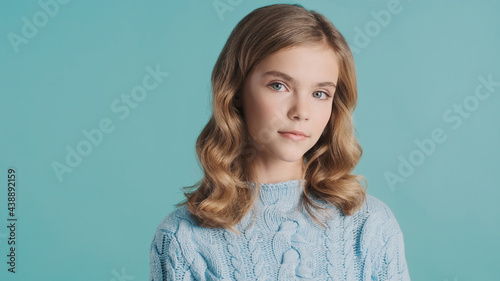 Beautiful haired teenager girl intently looking in camera posing