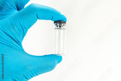 Glass bottle for vaccines on white background