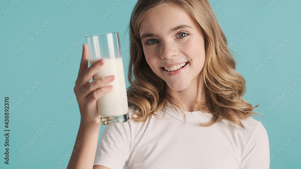 Beautiful teenage girl looking happy posing with milk on camera Beautiful teenage girl looking happy posing with milk on camera