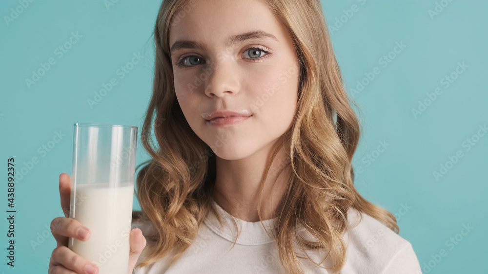Close up teenager girl drinking milk and having milk mustache ov Close up teenager girl drinking milk and having milk mustache ov