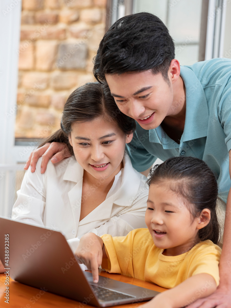 A Happy family of three using laptop A Happy family of three using laptop