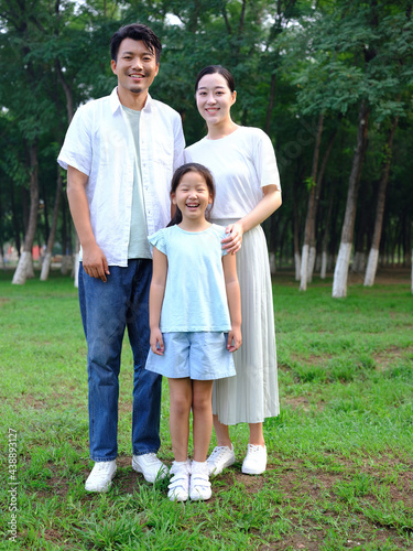 Happy family of three playing in the park © eastfenceimage