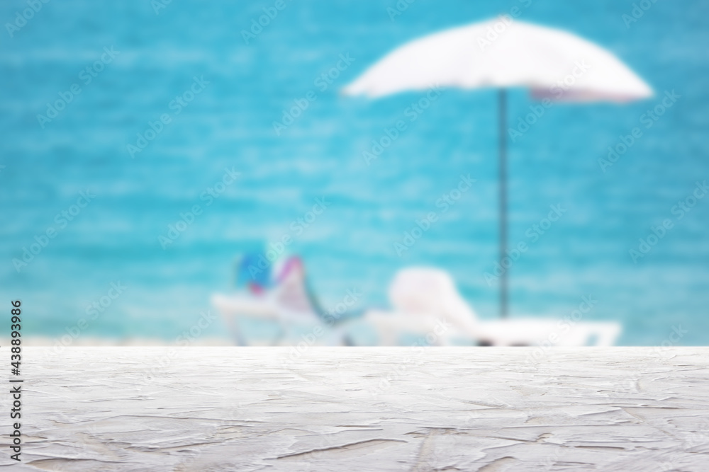 white textured surface on blur beach umbrella on the sea background