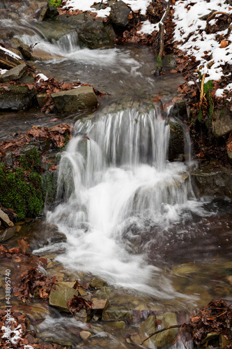Fototapeta Naklejka Na Ścianę i Meble -  Water flowing in the river between the stones in winter.