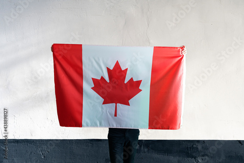 young man with a canada national flag on the soulders, patriotism and proud feelings photo