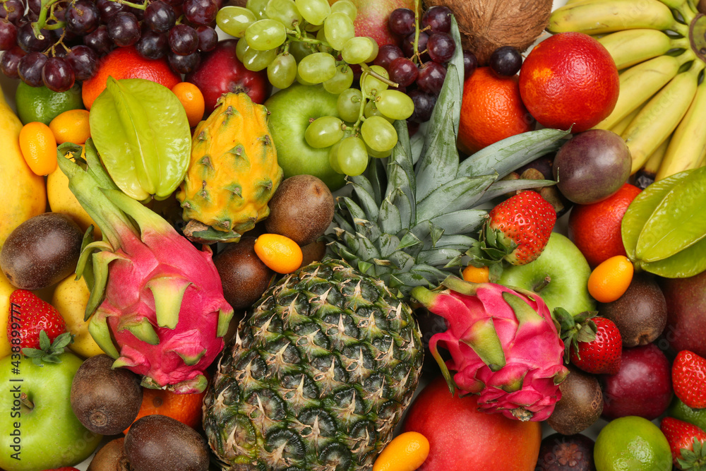 Assortment of fresh exotic fruits as background, top view