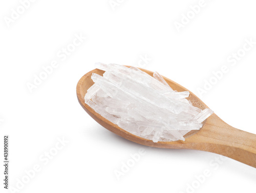 Menthol crystals in spoon on white background
