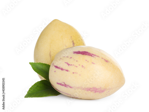 Fresh ripe pepino melons and green leaves on white background