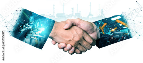 Mechanized industry robot arm and business handshake double exposure . Concept of successful agreement of artificial intelligence for industrial revolution and automation process in future factory .