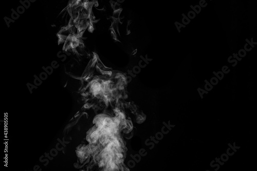 White smoke on black background. Figured smoke on a dark background. Abstract background, design element
