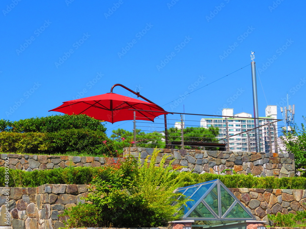 Summer scenery with red parasol
