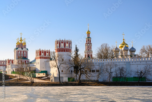 View of the fortress walls and temples of the Novodevichy Monastery with golden domes in Moscow, Russia