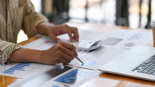 Accountant analyzing financial graph on office desk.