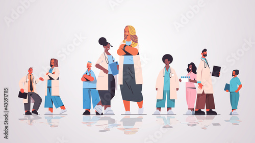female doctor leader standing in front of mix race medical professionals team in uniform medicine healthcare