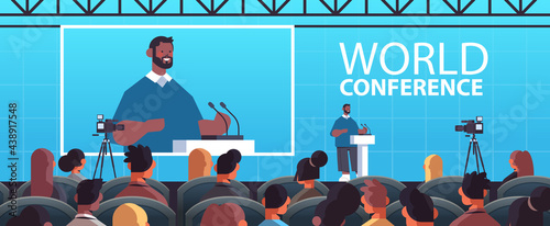 businessman giving speech at tribune with microphone on corporate international world conference