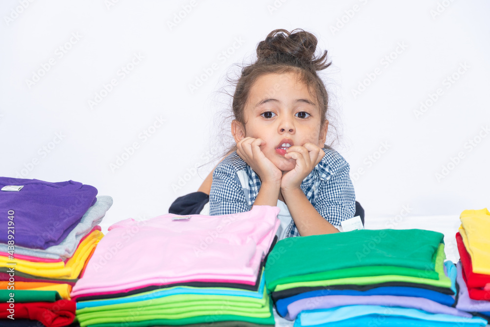 .Handsome stylish little boy wearing a plaid shirt over a white t-shirt poses in a white scene. .white background.studio shot. The concept of independent play of the child.. .Handsome stylish little boy wearing a plaid shirt over a white t-shirt poses in a white scene. .white background.studio shot. The concept of independent play of the child..