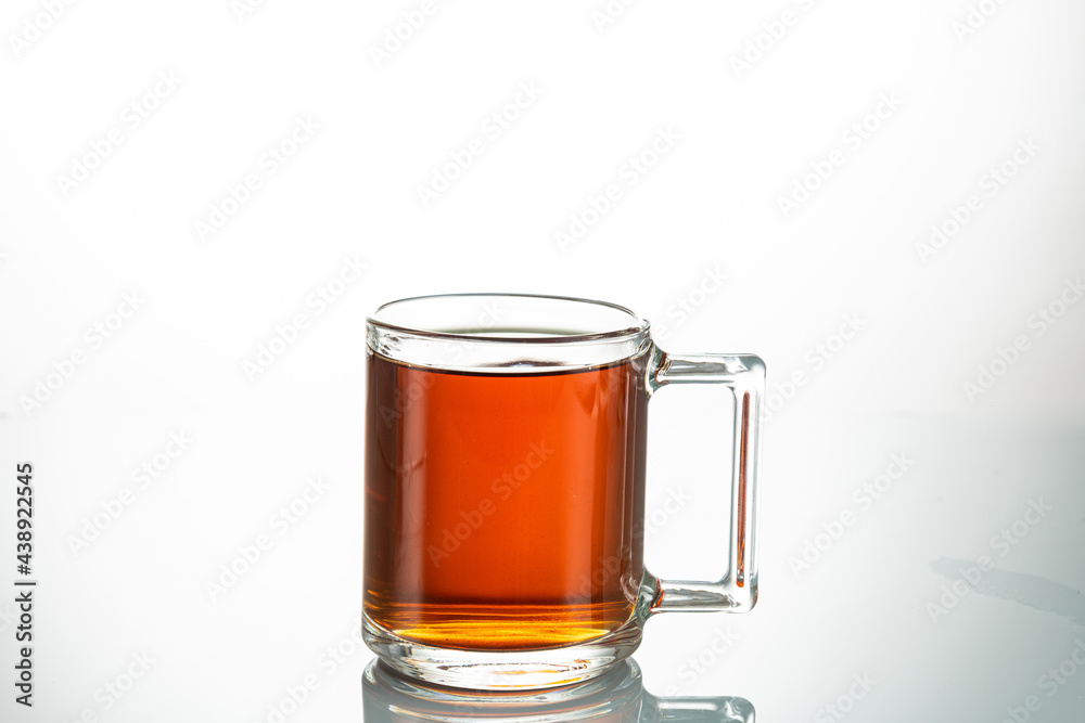 making tea from a tea bag in a transparent mug on a white background making tea from a tea bag in a transparent mug on a white background