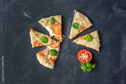 homemade pizza with tomato and basil