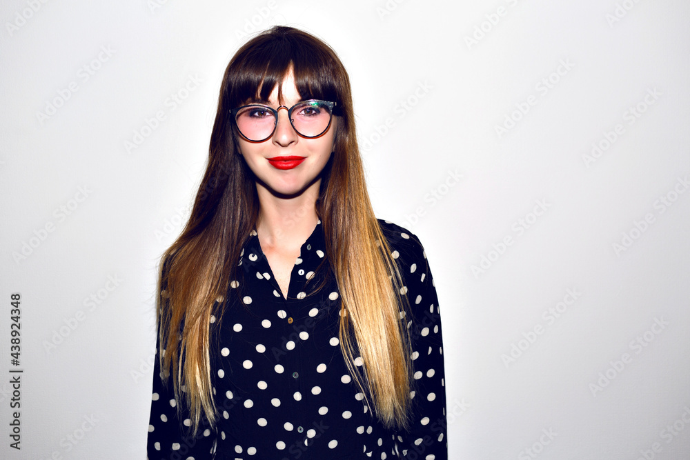 Stylish studio portrait of young hipster woman posing at white background Stylish studio portrait of young hipster woman posing at white background