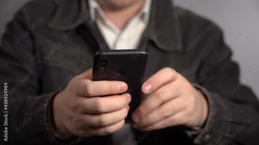 A Man Does His Small Business From A Smartphone. Problems of the Beginner Businessman. A Man Does His Small Business From A Smartphone. Problems of the Beginner Businessman.