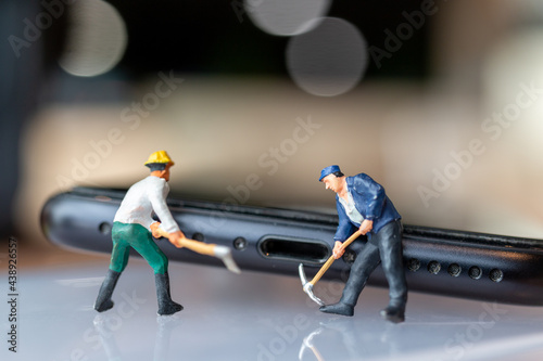 Miniature people Worker with tools repairing mobile phone