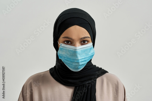 Portrait of young arabian girl in hijab and mask