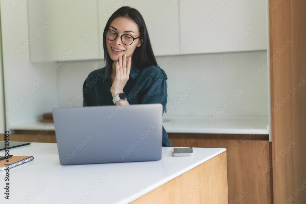Front view of business woman working from home with laptop, smartphone and notebook Front view of business woman working from home with laptop, smartphone and notebook