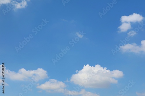 Clear blue sky with white clouds in summer time. Nature background concept. © Aungsumol