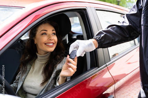 Valet Parking Giving Car Key To Woman
