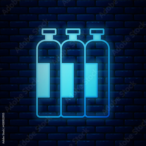 Glowing neon Industrial gas cylinder tank for all inert and mixed inert gases icon isolated on brick wall background. Vector