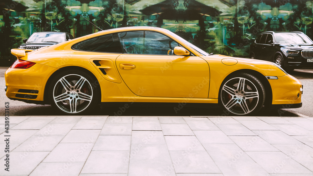 Yellow Porsche 997 Turbo car parked on the street in the city. Porsche ...