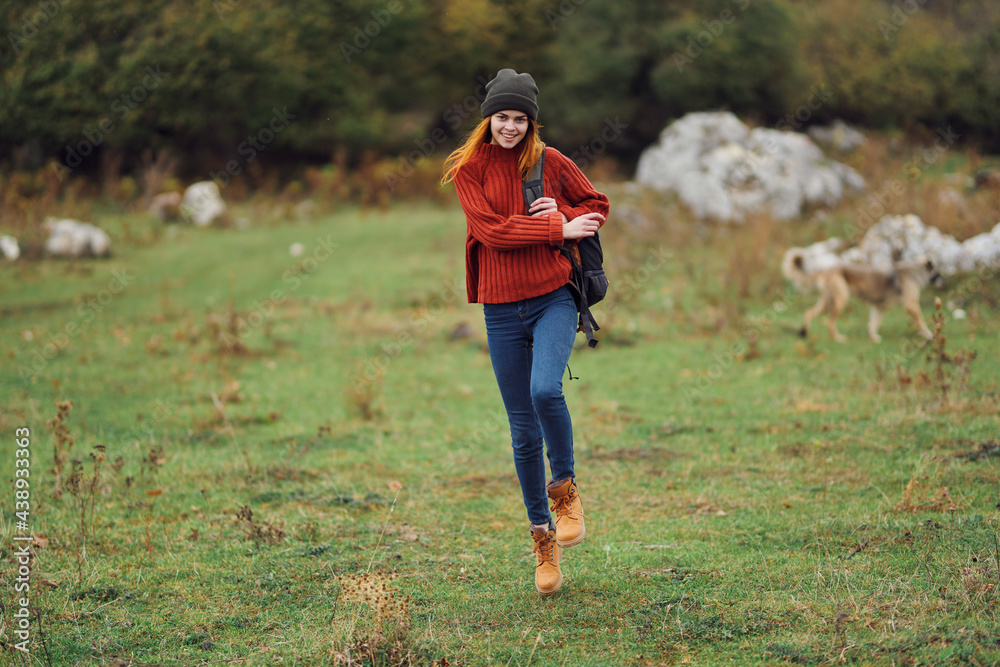 woman hiker with backpack walking in the field travel mountains fun woman hiker with backpack walking in the field travel mountains fun