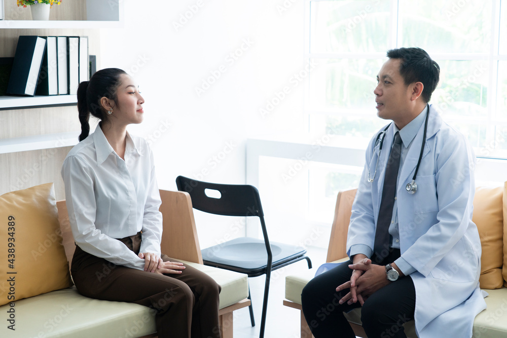 Male doctor gives advice to female patient to treat sickness at hospital. Male doctor gives advice to female patient to treat sickness at hospital.