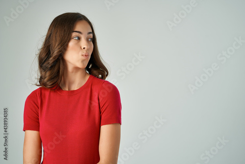 woman in red t-shirt fashion modern style casual wear light background