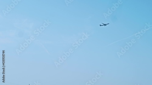 View of plane in blue clear sky. Plane is landing.