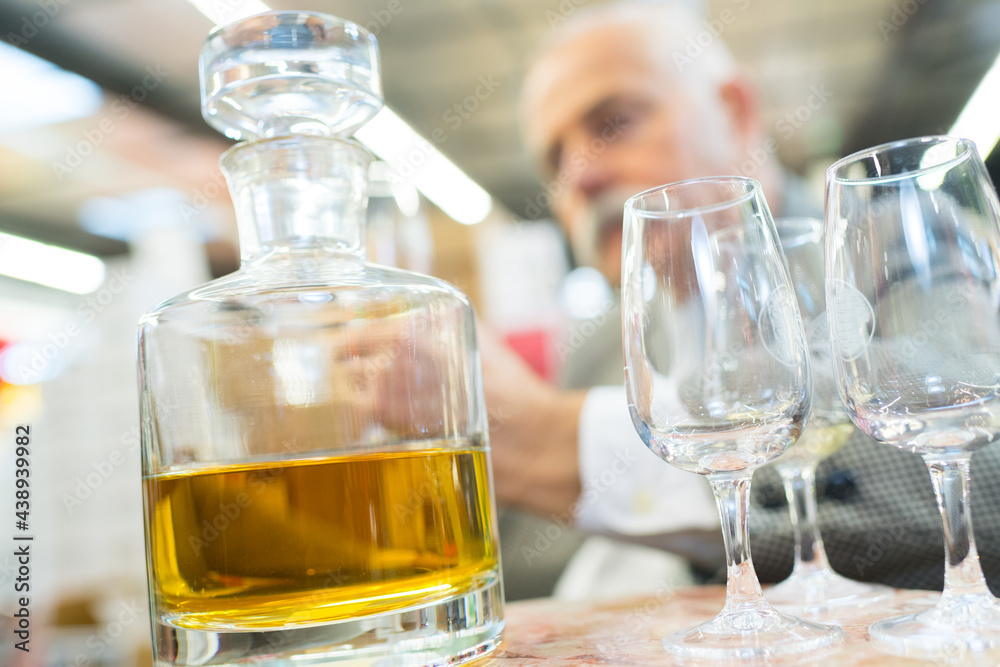 man with carafe or yellow drink man with carafe or yellow drink