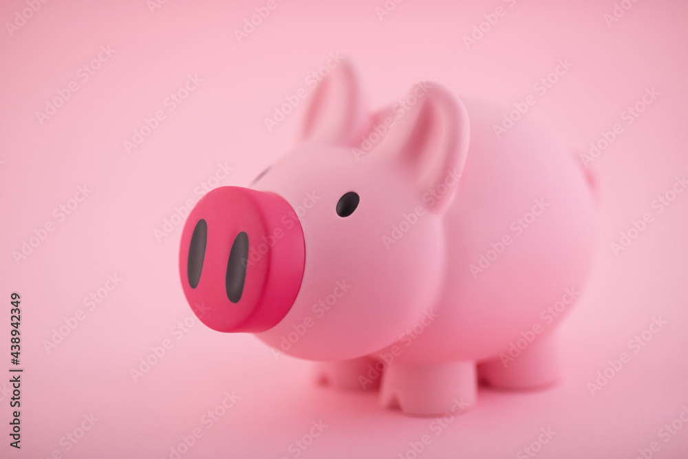 Pink piggy bank on pink background Pink piggy bank on pink background